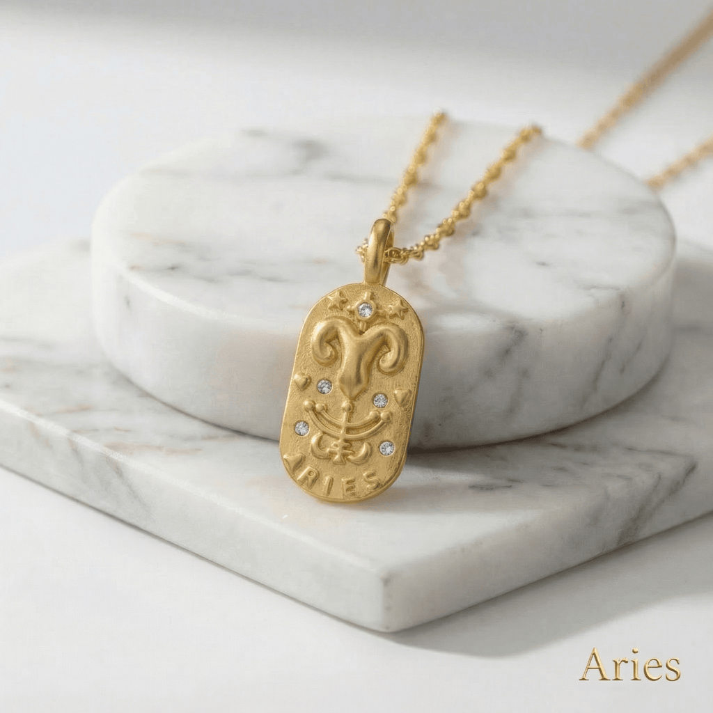 Aries Gold Engraved Zodiac Sign Necklace on a marble surface