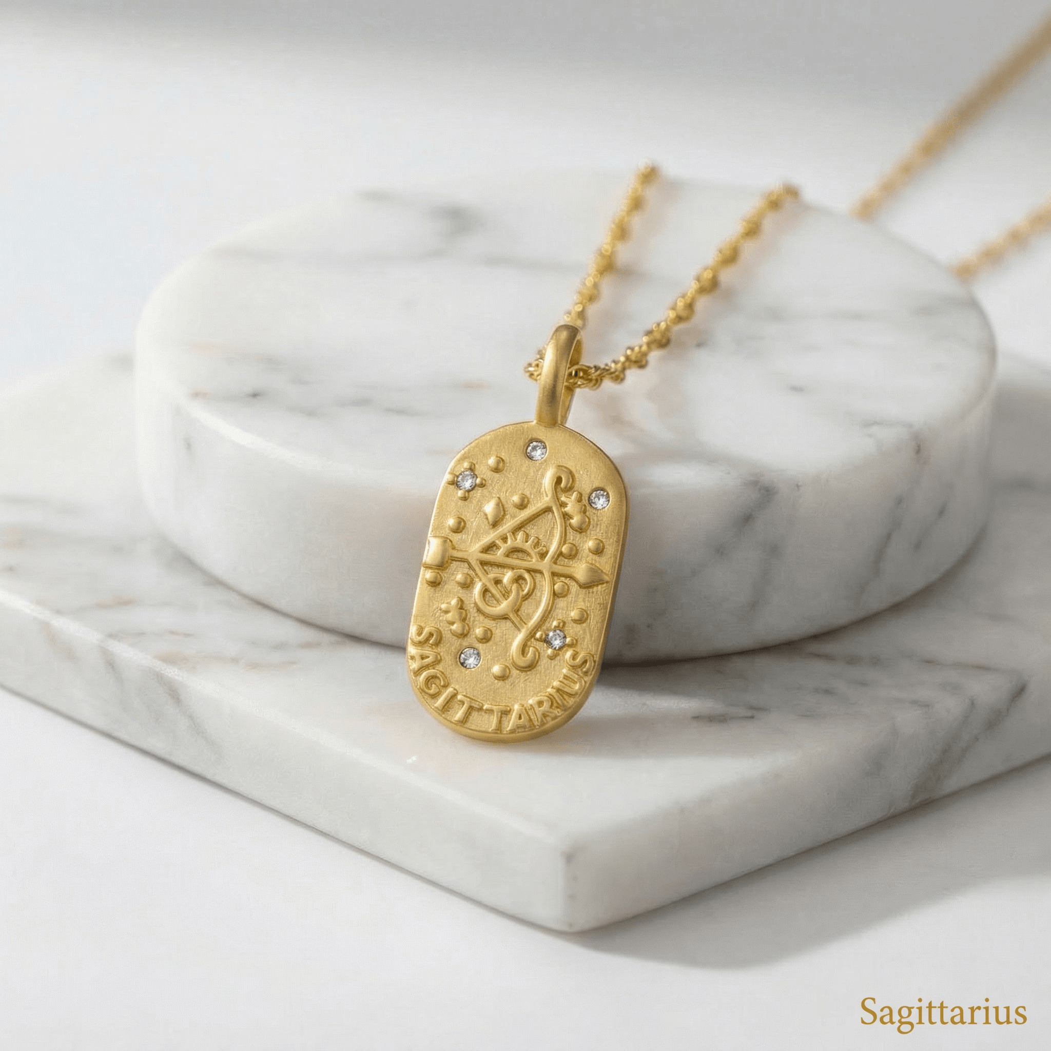 Sagittarius Gold Engraved Zodiac Sign Necklace on a marble surface with 'Sagittarius' text.