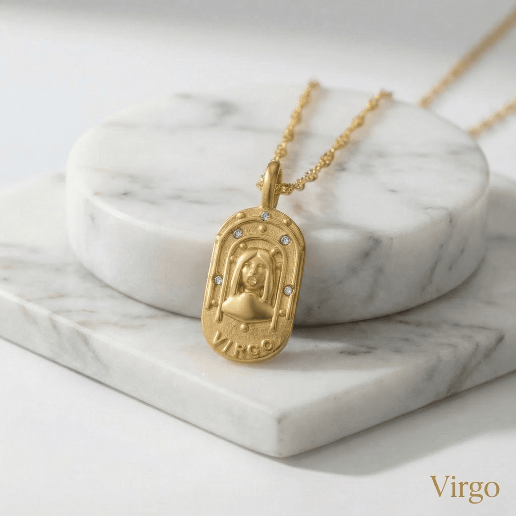 Virgo Gold Engraved Zodiac Sign Necklace on a marble surface