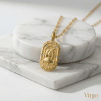 Virgo Gold Engraved Zodiac Sign Necklace on a marble surface