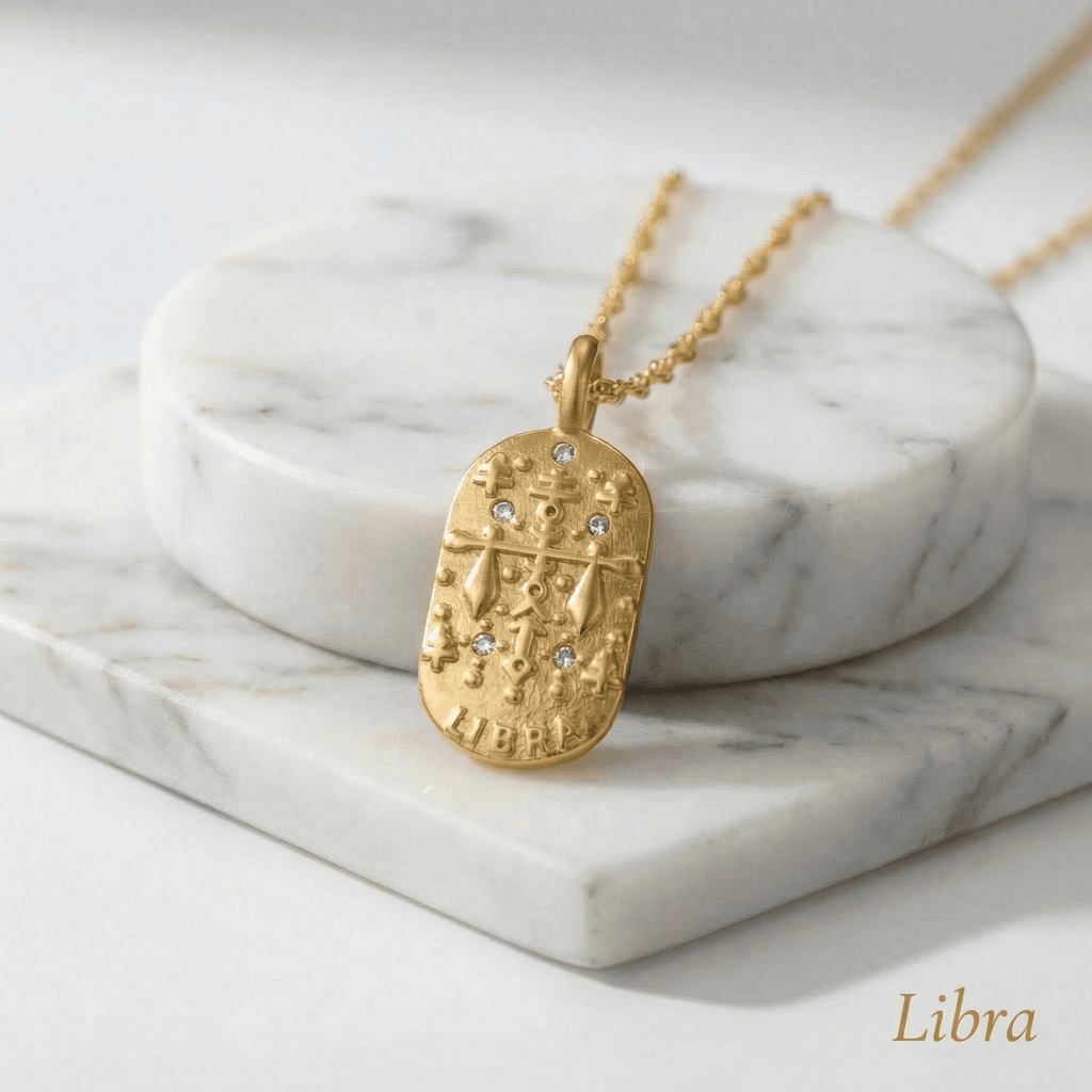 Libra Gold Engraved Zodiac Sign Necklace on a marble surface with 'Libra' text
