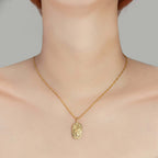 Gold Engraved Zodiac Sign Necklace displayed on a model's neck, showcasing its detailed zodiac symbol and gold finish.