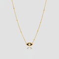 Gold Evil Eye Mini Charm Necklace on plain background