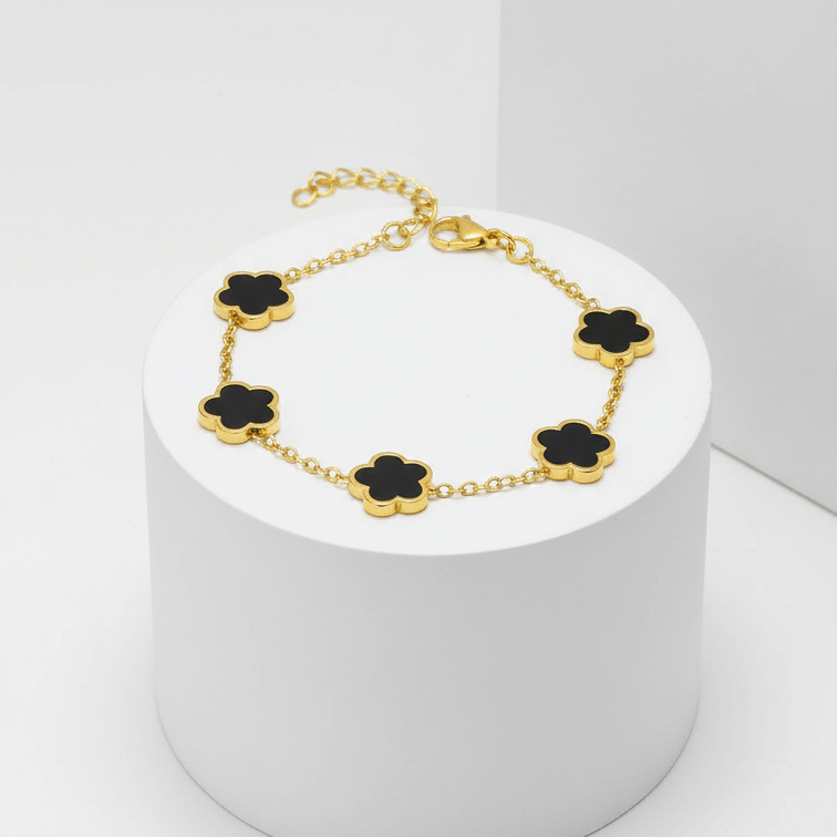 Gold Five Clover Bracelet showcasing black floral motifs on a polished gold-tone chain.