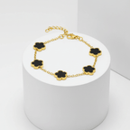 Gold Five Clover Bracelet showcasing black floral motifs on a polished gold-tone chain.
