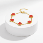Gold Five Clover Bracelet in red on pedestal