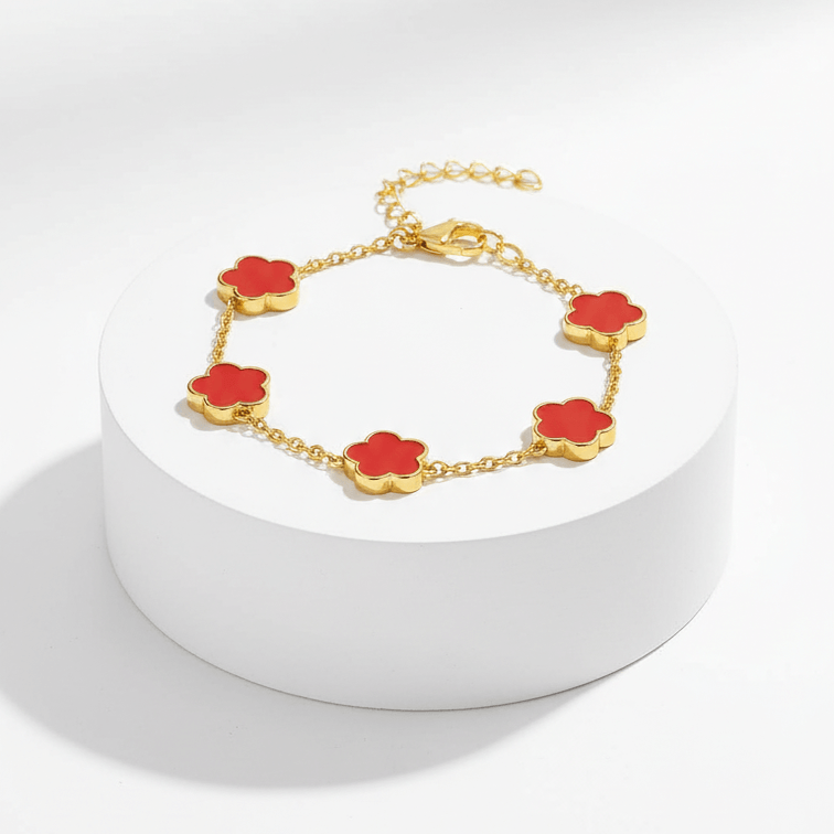 Gold Five Clover Bracelet in red on pedestal