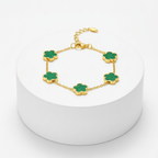 Gold Five Clover Bracelet on green on pedestal