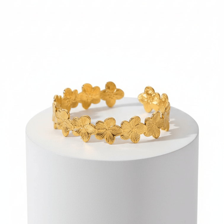 Gold Floral Cuff Bracelet on whit pedestal