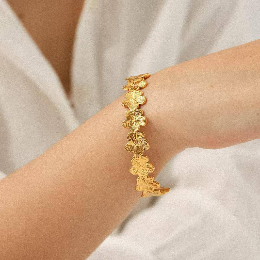 Gold Floral Cuff Bracelet on model hand