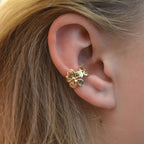 Gold Floral Ear Cuff Set worn on a person's ear with blonde hair.