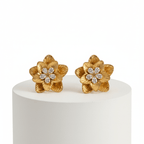 Gold Floral Shaped Stud Earrings on a white pedestal against a white background