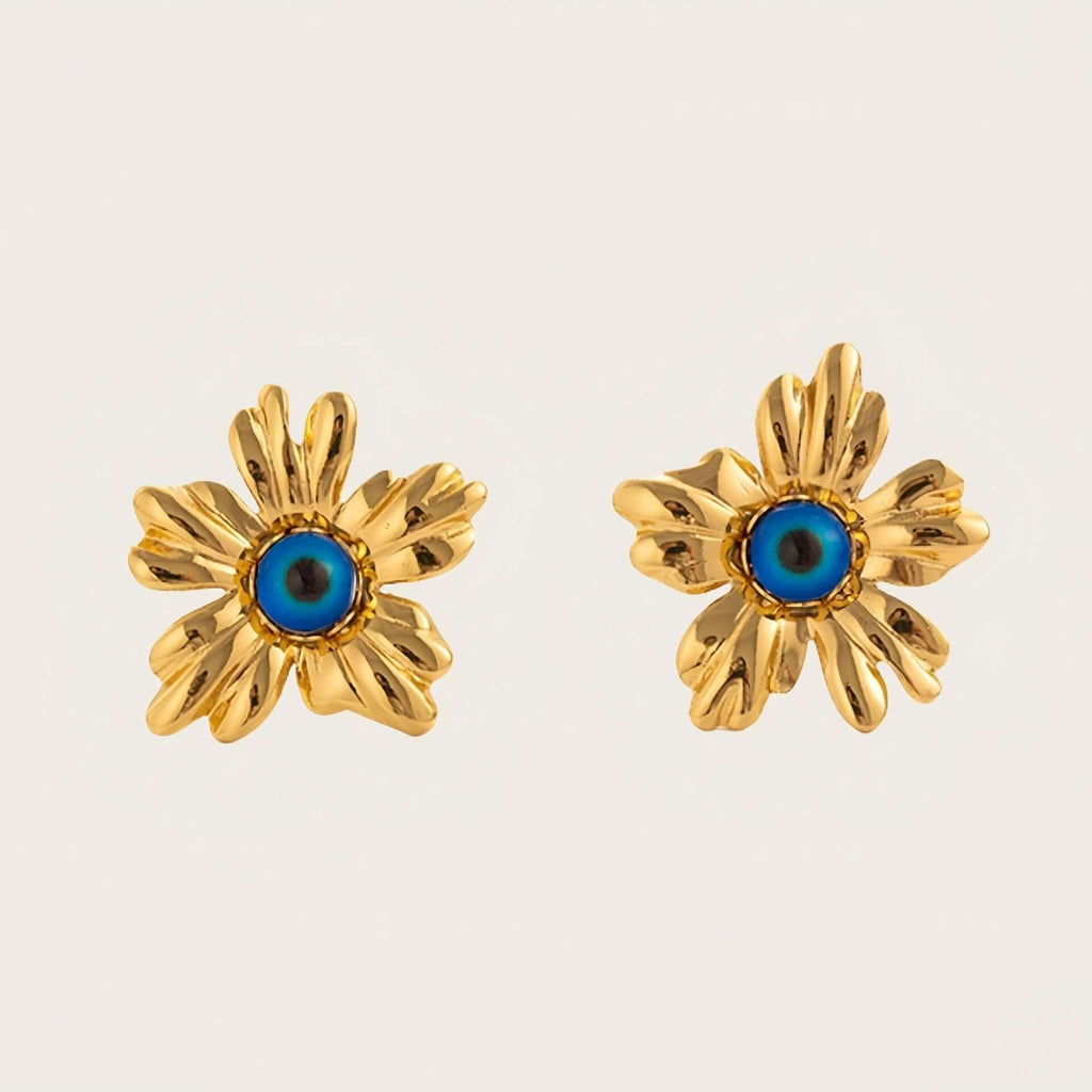 Gold Floral Stud Earrings with Blue Stone with blue centres on a light beige background