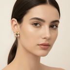 Gold Floral Stud Earrings with Blue Stone on model
