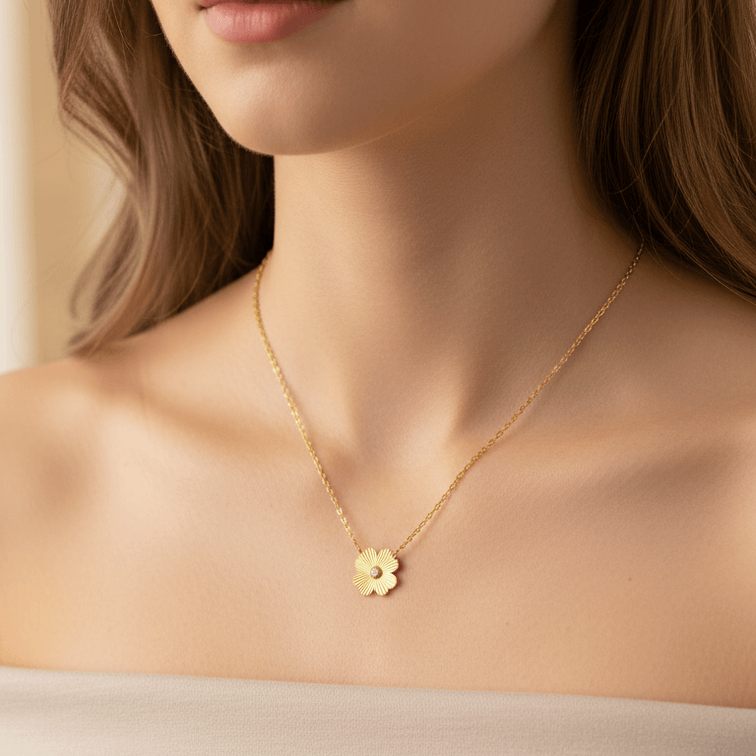 Woman wearing a Gold Flower Pendant Necklace with a small pendant
