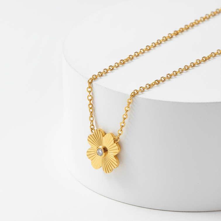 Gold Flower Pendant Necklace with a flower pendant on a white background