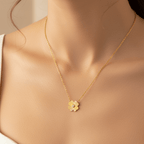Gold Flower Pendant Necklace with a flower pendant worn by a model