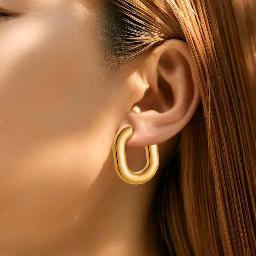 Ceyrah Gold Half Hoop Earrings on woman with straight brown hair