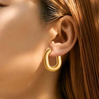 Ceyrah Gold Half Hoop Earrings on woman with straight brown hair