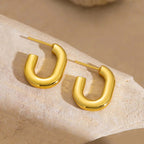 Ceyrah Gold Half Hoop Earrings with modern U-shape design on stone background
