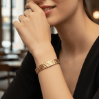 Woman wearing a Gold Hammered Cuff Bracelet with a blurred indoor background