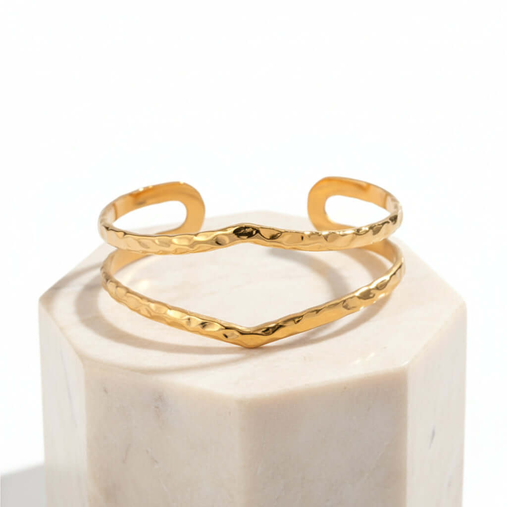 Gold Hammered Wave Cuff Bracelet on a white background