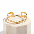 Gold Hammered Wave Cuff Bracelet on a white background