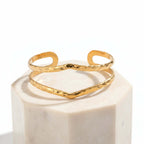 Gold Hammered Wave Cuff Bracelet on a white background
