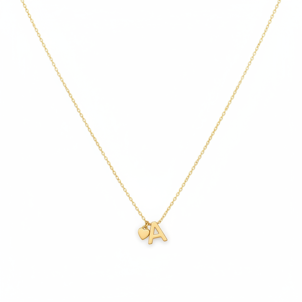 A delicate gold chain necklace featuring a small heart-shaped charm and a polished letter 'A' pendant, displayed against a solid white background.