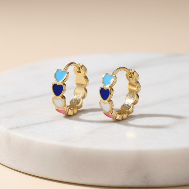 Gold Heart Charm Hoop Earrings with colorful heart-shaped stones on a beige background