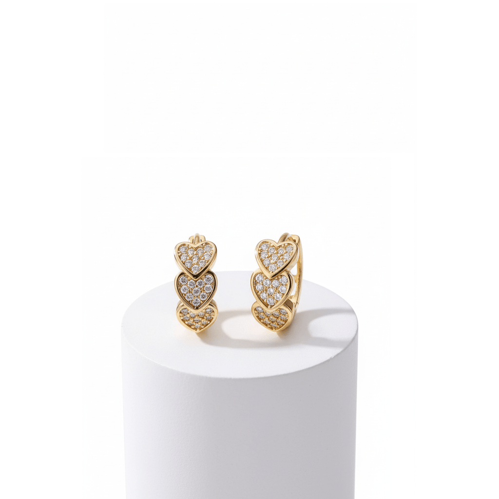 Gold Heart Crystal Cluster Hoop Earrings on a white pedestal with a white background