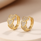 Gold Heart Crystal Cluster Hoop Earrings on a beige background