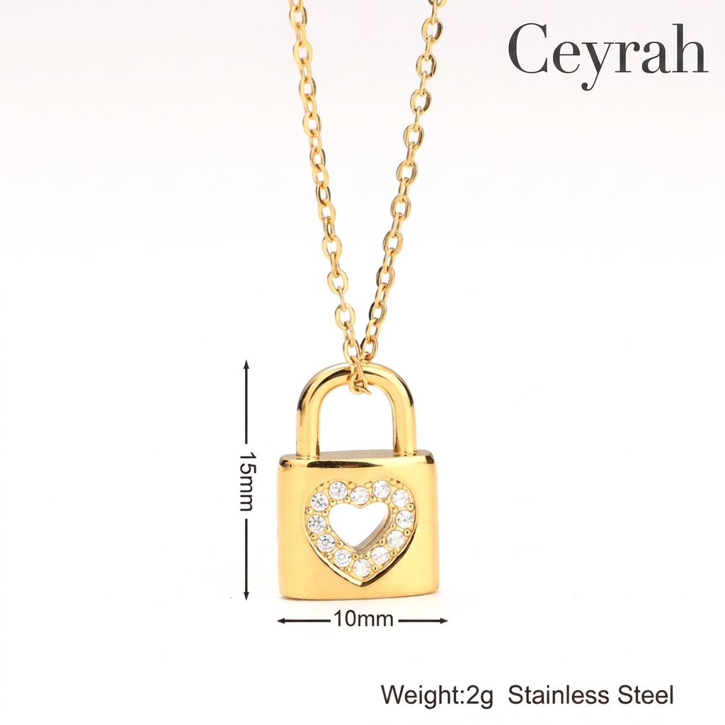 Gold Heart Padlock Necklace with a heart-shaped crystal border, shown on a white background with dimension lines indicating 15mm height, 10mm width, and weight text reading 2g Stainless Steel.