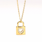 Gold Heart Padlock Necklace featuring a padlock pendant with a heart-shaped cutout adorned with small clear stones, suspended from a delicate gold chain against a plain white background.