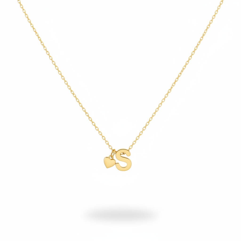 Gold Heart & S Initial Pendant Necklace displayed against a solid white background with a soft shadow underneath.