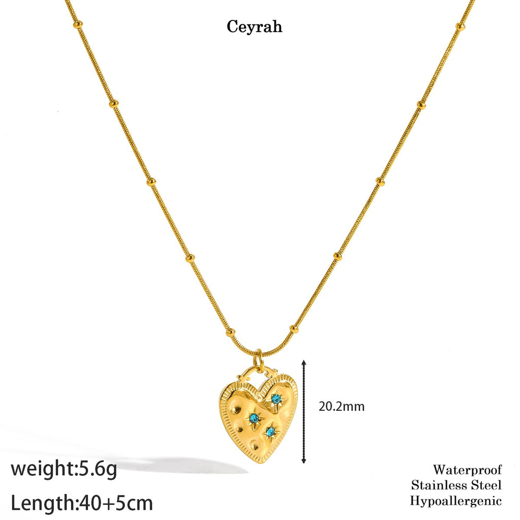 Gold Heart Turquoise Gemstone Necklace on a white background with text showing weight, length, and material details. The pendant has small turquoise-blue stones and is labeled 'Ceyrah'.