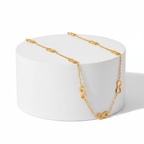 Gold Infinity Necklace on white pedestal