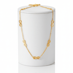 Gold Infinity Necklace on white long pedestal