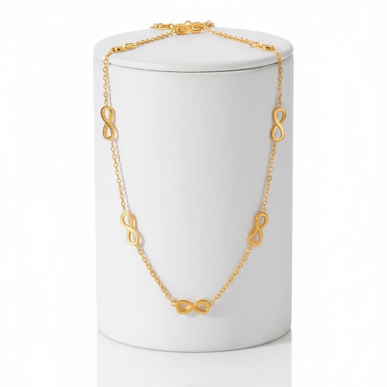 Gold Infinity Necklace on white long pedestal