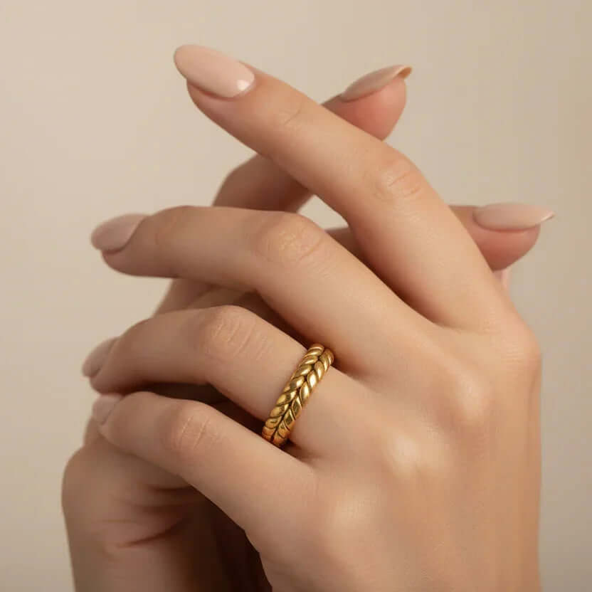 Ceyrah Gold Interlocking Leaf Ring on hand with nude manicured nails