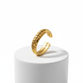 Gold Interlocking Leaf Ring displayed on a white pedestal showcasing its intricate interlocking leaf design.
