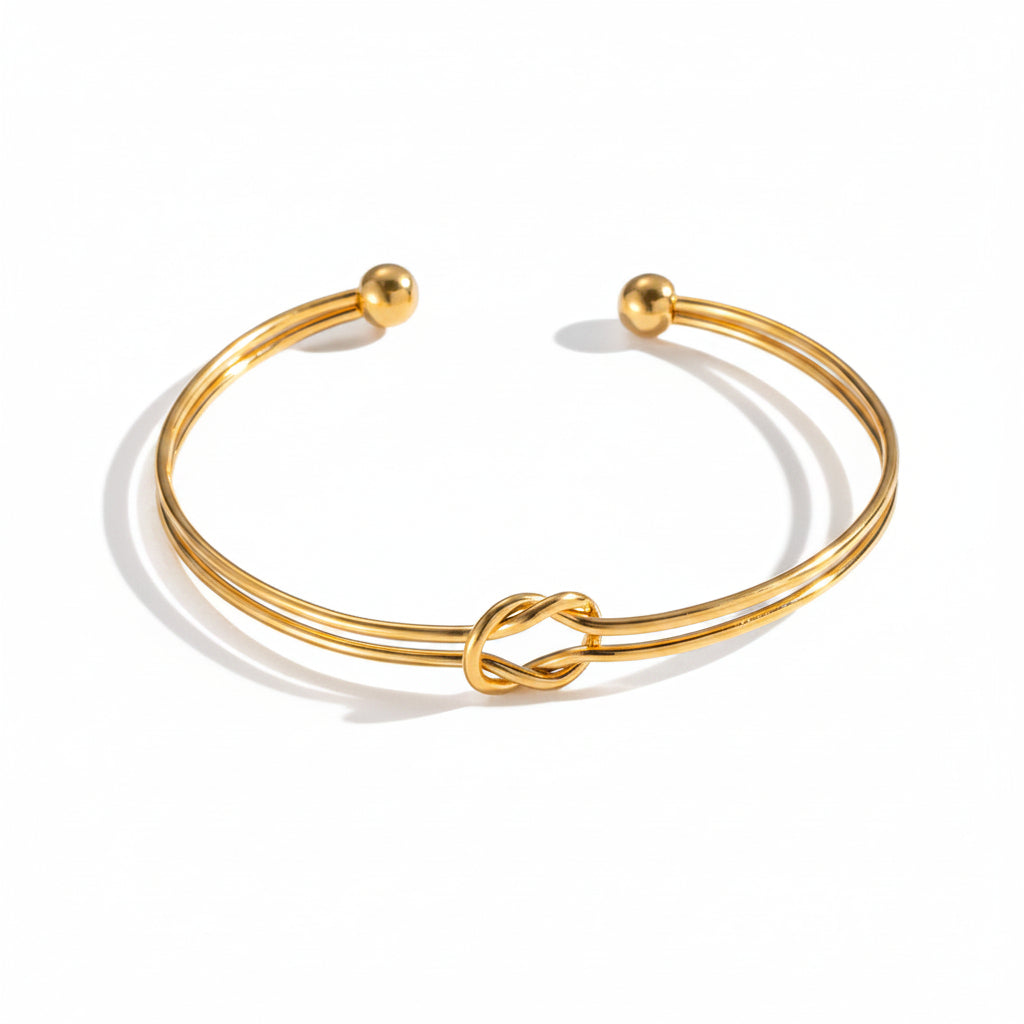 Gold Knot Cuff Bracelet plain background 