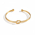 Gold Knot Cuff Bracelet plain background 