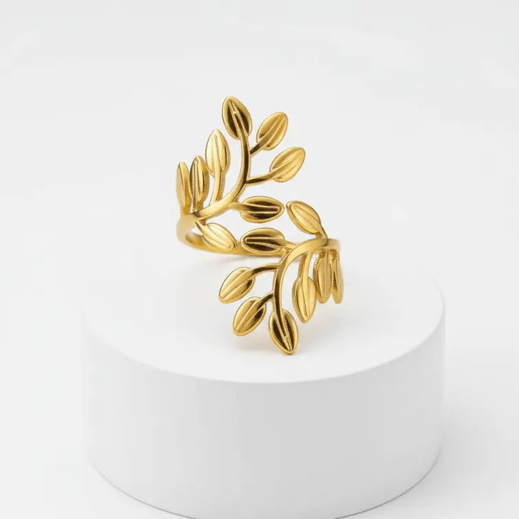 Gold Leaf Branch Adjustable Ring on a white pedestal against a white background