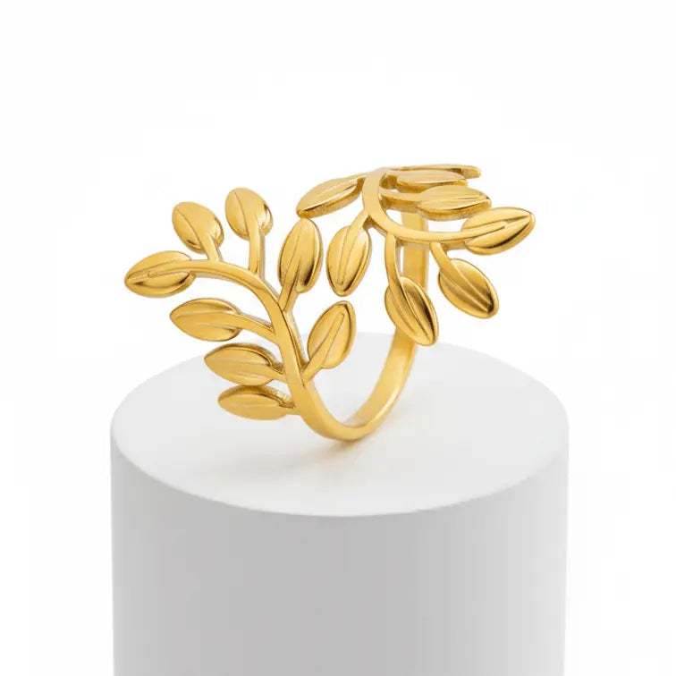 Gold Leaf Branch Adjustable Ring  on a white pedestal with a white background