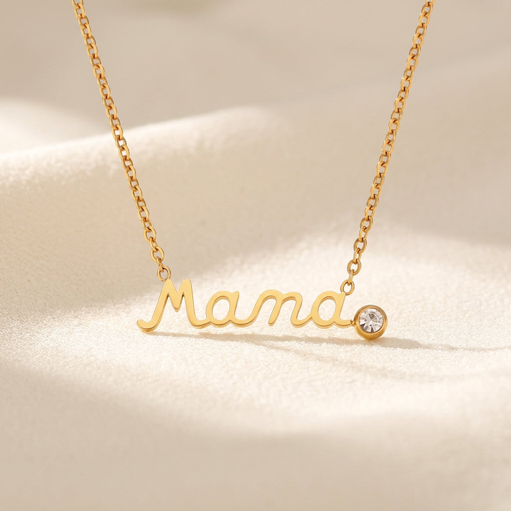 Gold cursive 'Mama' nameplate Gold Mama Necklace With Rhinestone Detail with a small round clear gemstone, shown with measurement annotations including 1.4mm chain width, 25.