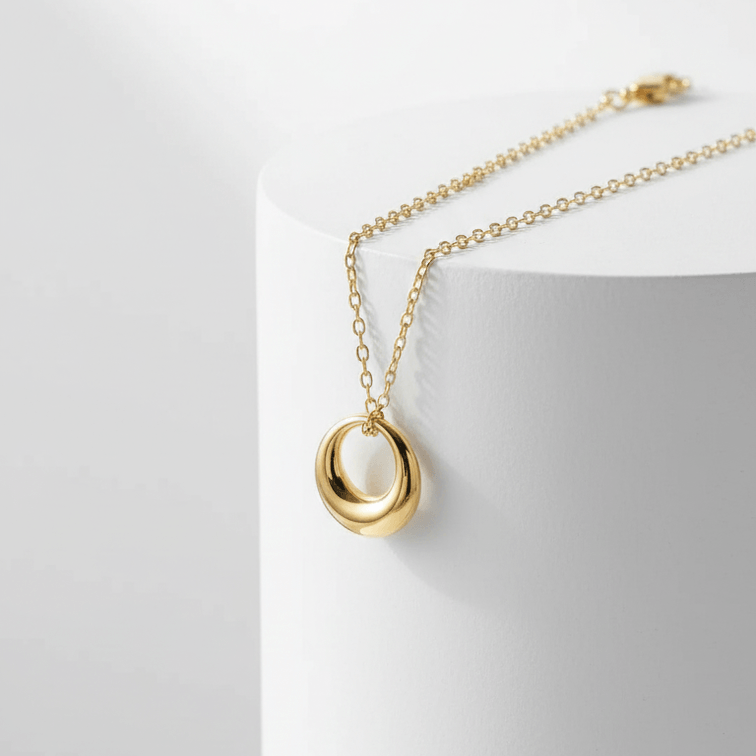 Mini gold Circle Pendant Necklace in gold on pedestal