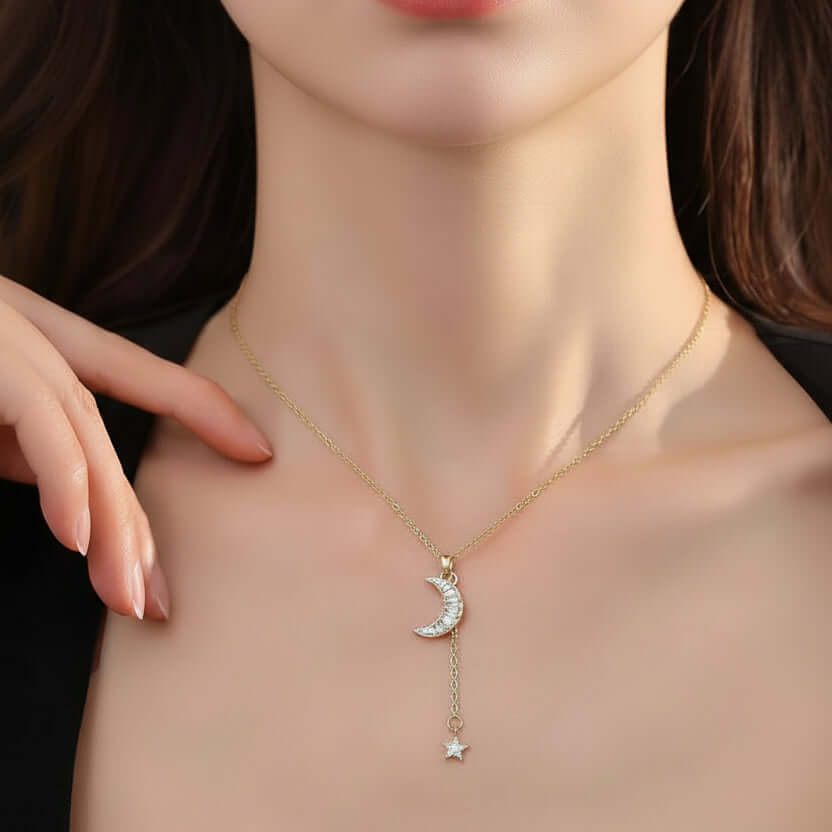 Gold Moon & Star Celestial Necklace  with a moon and star pendant on a person's neck