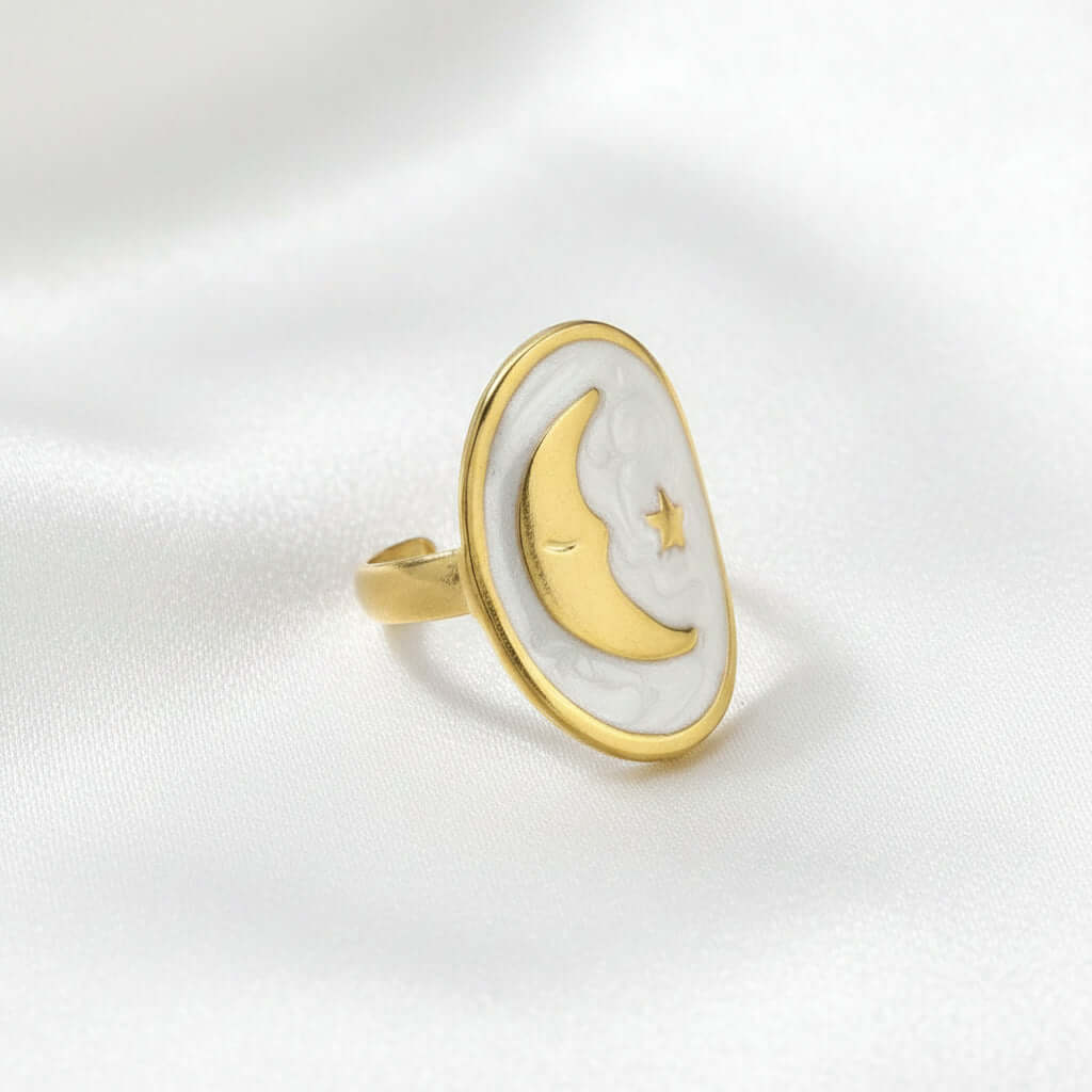 Gold Moon and Star Oval Ring on a soft background, featuring a crescent moon and star design, elegant and celestial.
