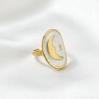 Gold Moon and Star Oval Ring on a soft background, featuring a crescent moon and star design, elegant and celestial.